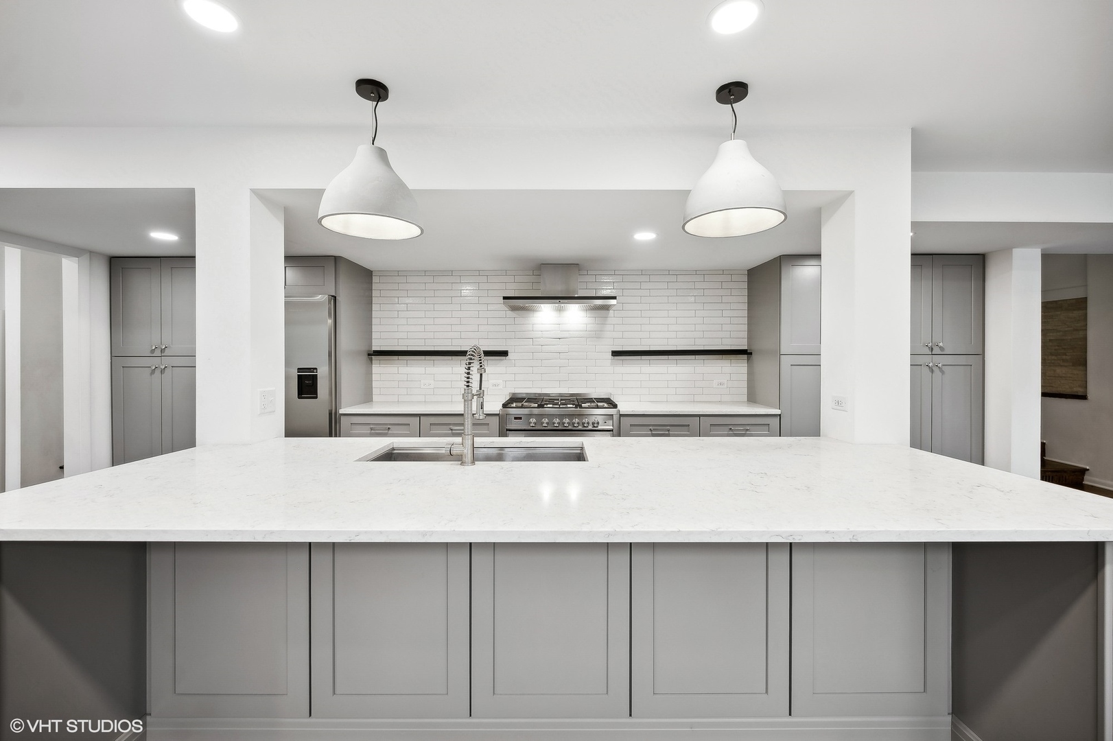 558 Sunset Lane Glencoe, IL 60022 - Photo 8 of 22 a kitchen with stainless steel appliances a table a refrigerator and cabinets
