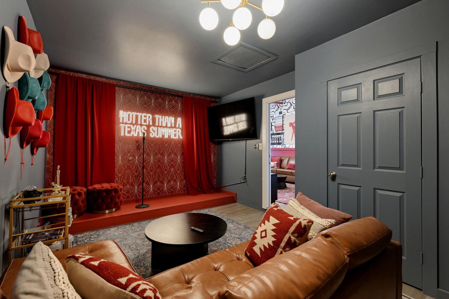 3410 Plantation Road Austin, TX 78745 - Photo 4 of 33 A vibrant entertainment room offers a dedicated stage area and inviting lounge seating for memorable gatherings.