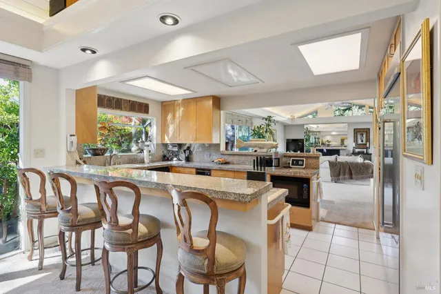 a kitchen with a table chairs refrigerator and cabinets