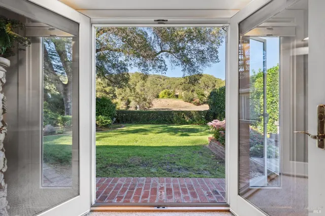a view of a back yard from a room