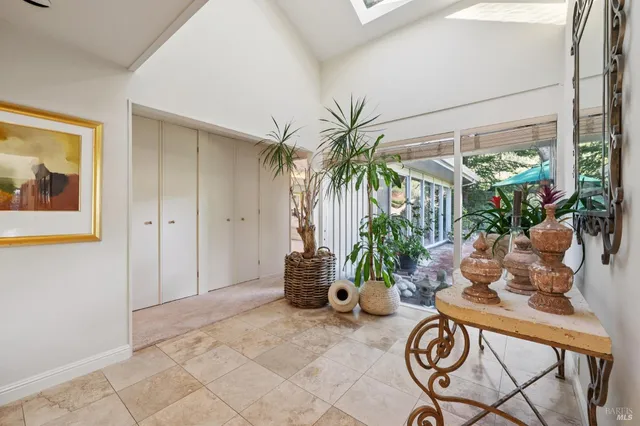 a living room with furniture a chandelier and a dining table