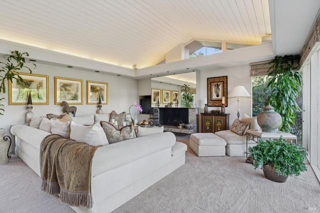a view of a backyard with table and chairs under an umbrella