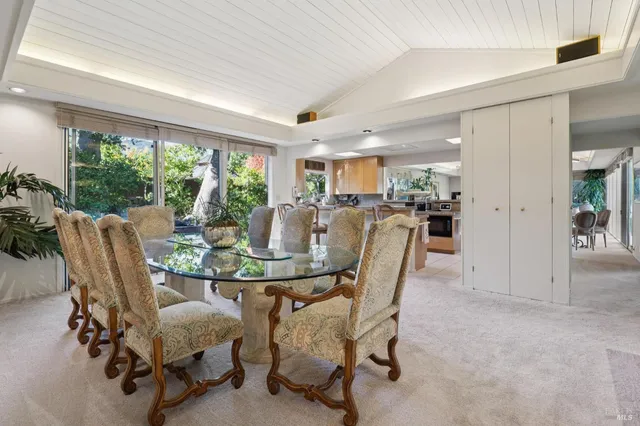 a dining room with furniture a table and chairs