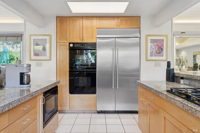 a kitchen with granite countertop a sink a stove and a wooden floor