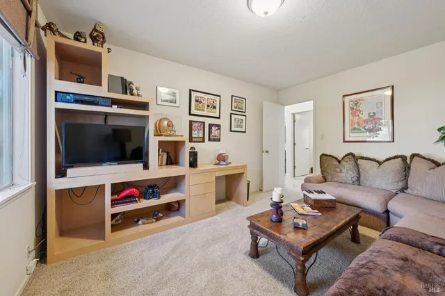 a living room with furniture a lamp and a window