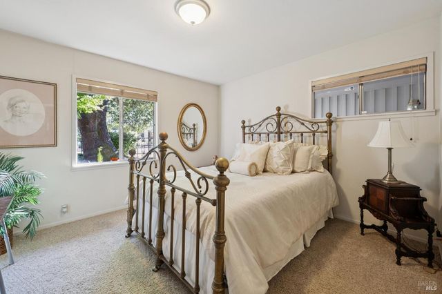 a bedroom with bed and a window