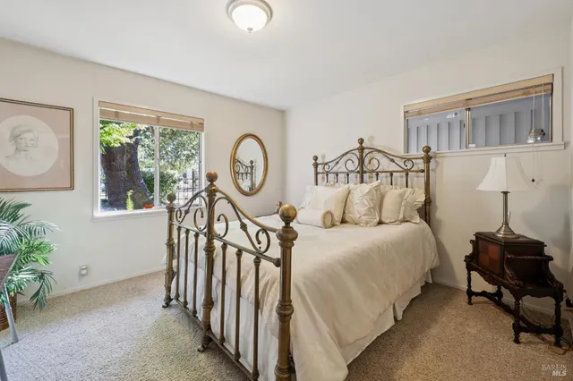 a bedroom with bed and a window