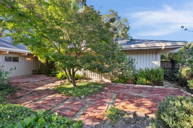 a view of a patio with table and chairs and potted plants