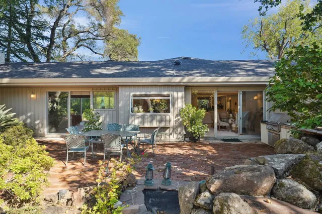 a front view of a house with outdoor seating