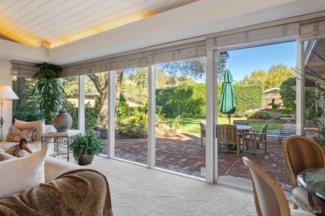 a living room filled with furniture and a floor to ceiling window