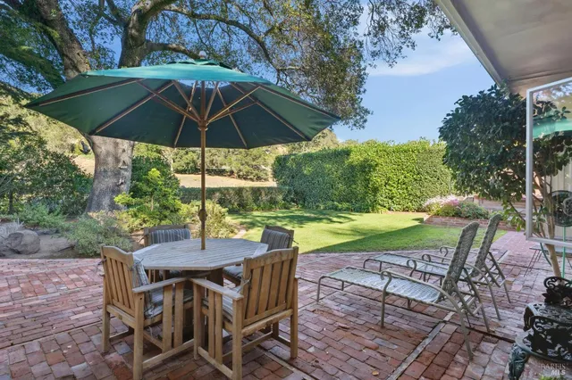 a view of an outdoor sitting area with swimming pool and garden
