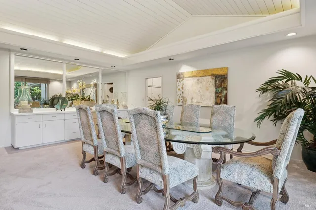 a view of a dining room with furniture and a potted plant