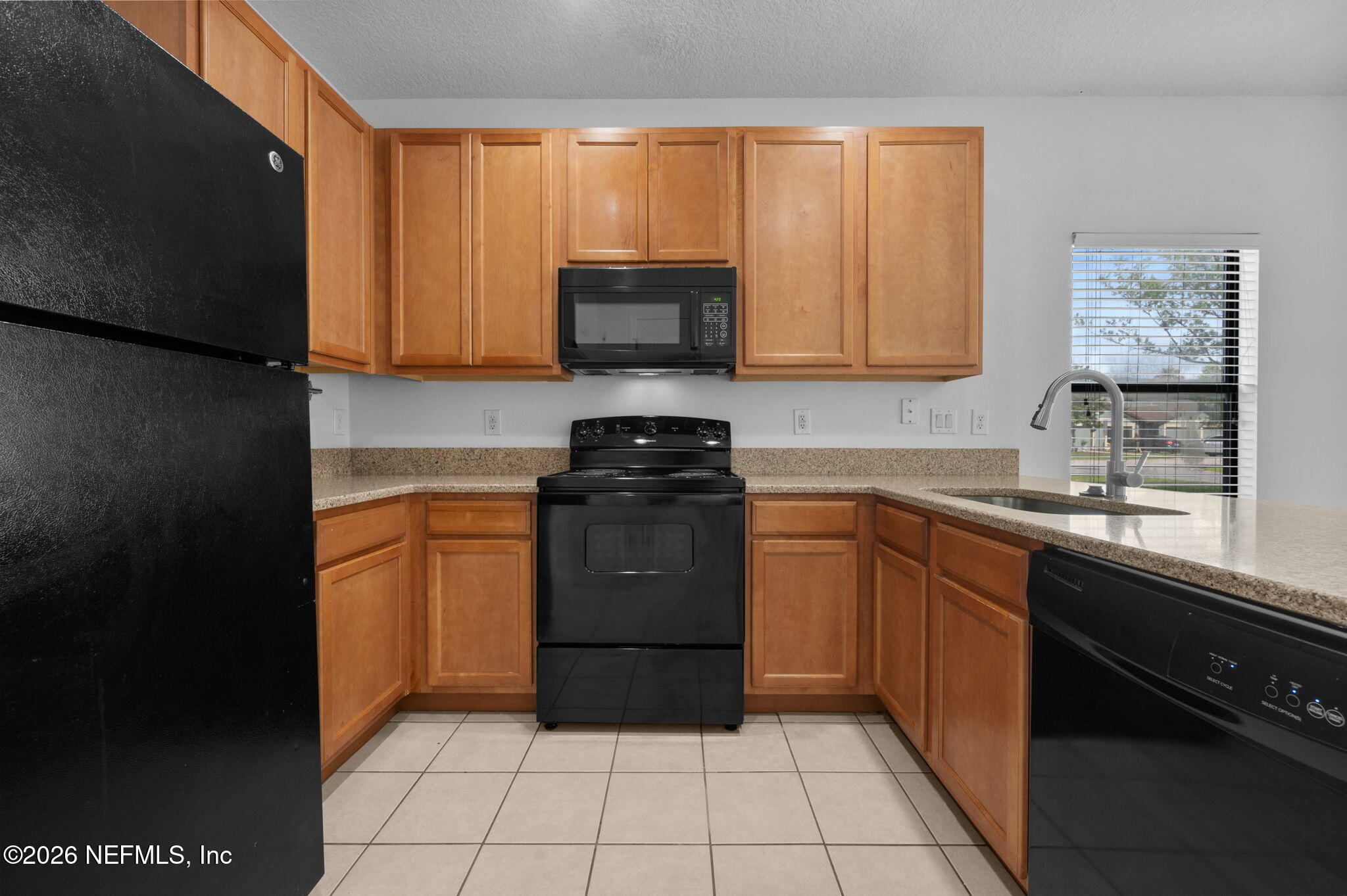253 Syrah Way St. Augustine, FL 32084 - Photo 9 of 39 a kitchen with a sink a stove cabinets and a window