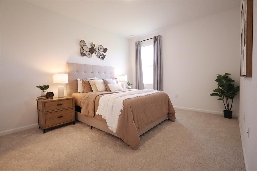 5719 Hiawassee Road Yalaha, FL 34797 - Photo 12 of 20 a bed room with a bed and a potted plant