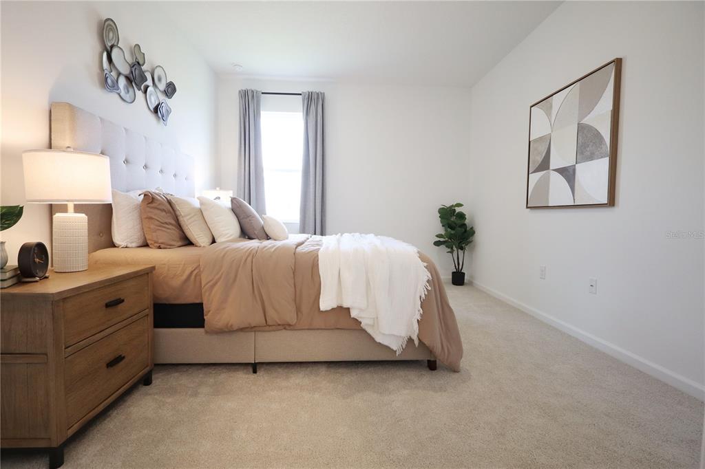 5719 Hiawassee Road Yalaha, FL 34797 - Photo 13 of 20 a bedroom with a bed and a night stand