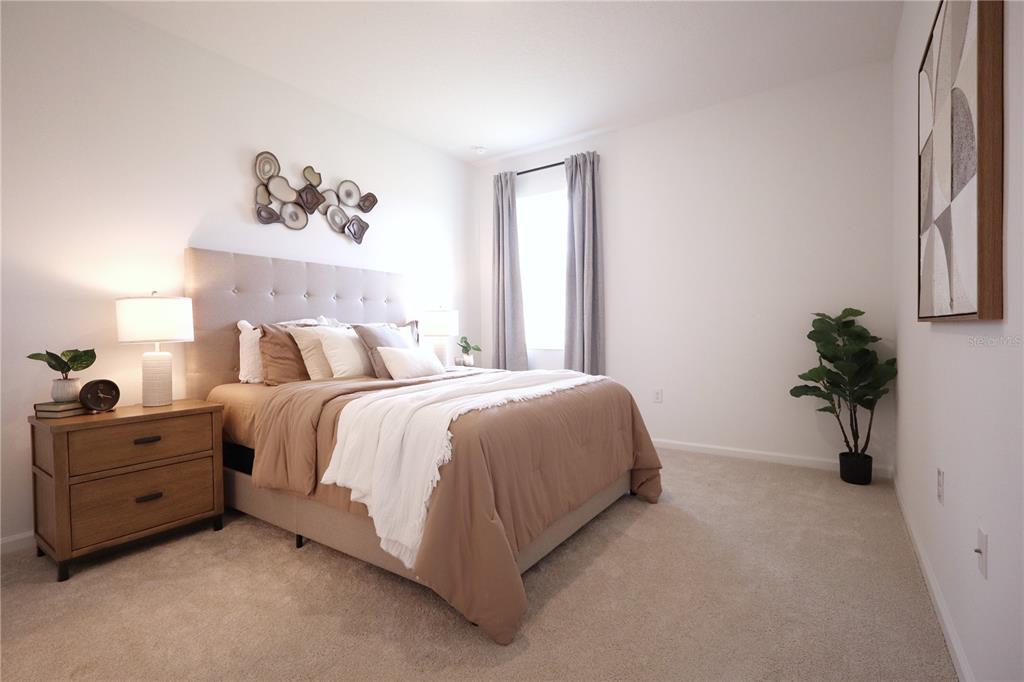 5719 Hiawassee Road Yalaha, FL 34797 - Photo 14 of 20 a bed room with a bed and a potted plant