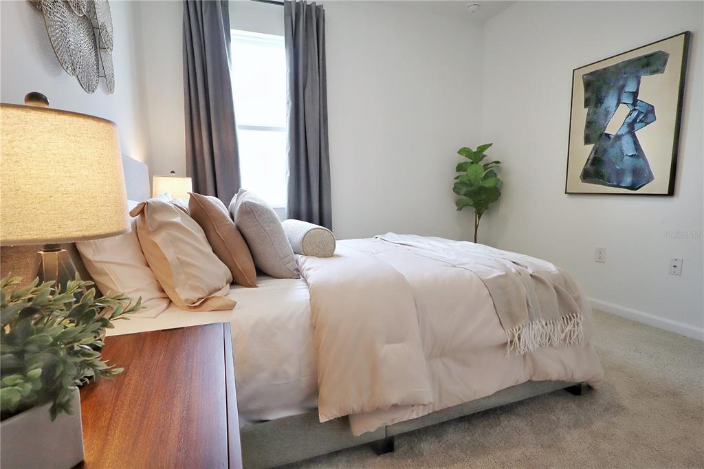 5719 Hiawassee Road Yalaha, FL 34797 - Photo 16 of 20 a bedroom with a bed and a painting on the wall