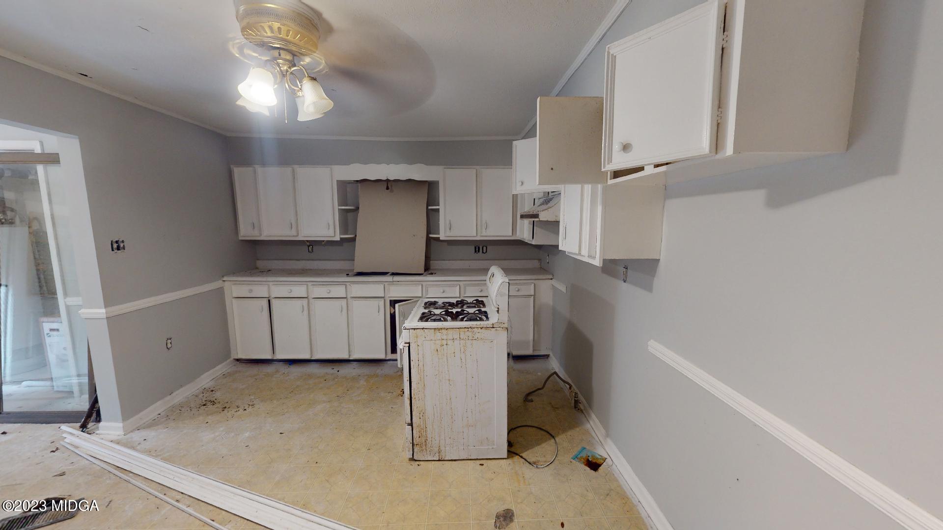 4521 Brookhaven Road Macon, GA 31206 - Photo 8 of 25 a kitchen with a sink appliances and cabinets
