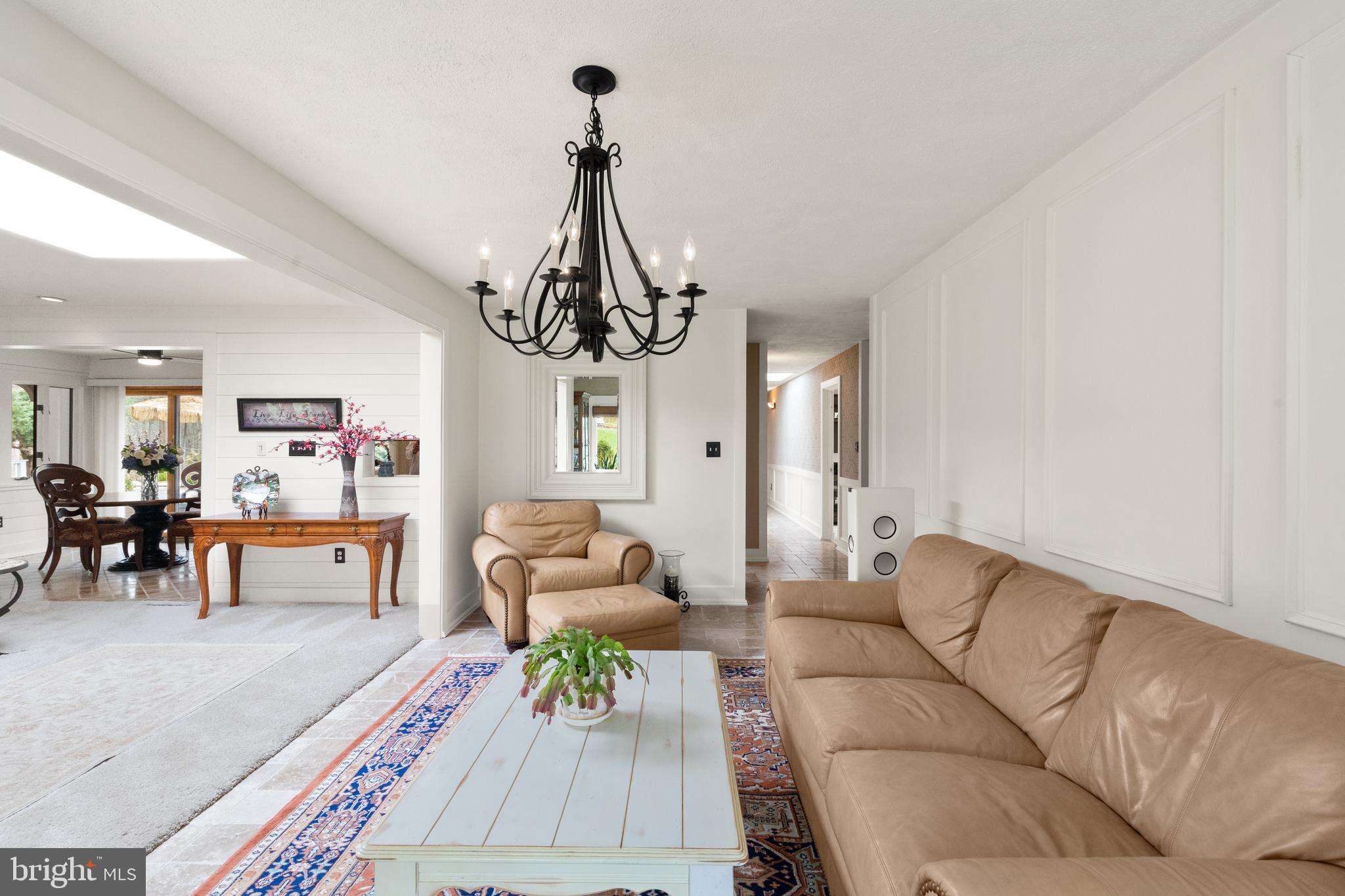 1403 Ellenglen Road Towson, MD 21286 - Photo 12 of 40 a living room with furniture and a chandelier