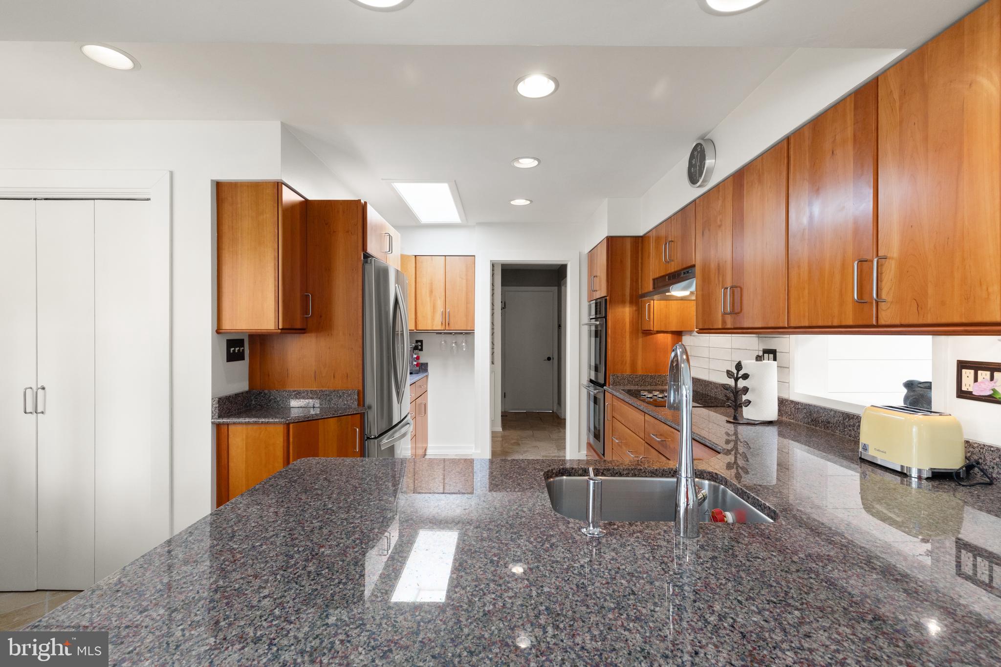 1403 Ellenglen Road Towson, MD 21286 - Photo 19 of 40 a kitchen with stainless steel appliances kitchen island granite countertop a refrigerator and cabinets