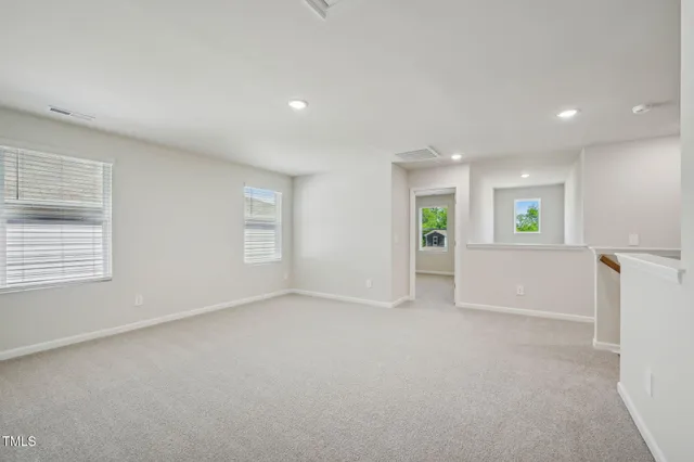 an empty room with windows and entrance