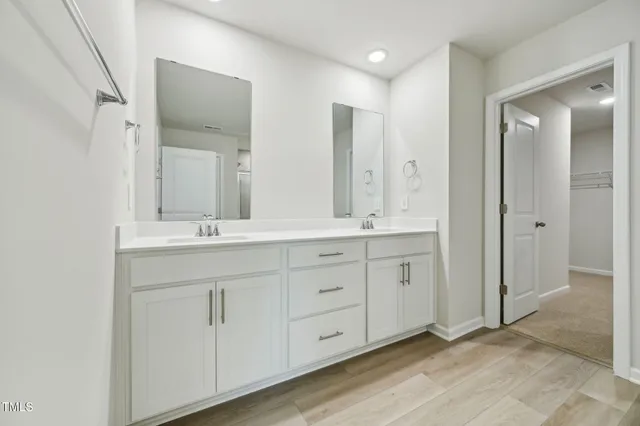 a bathroom with double sink and a mirror
