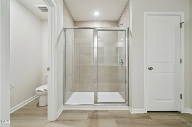 a bathroom with a shower and a toilet