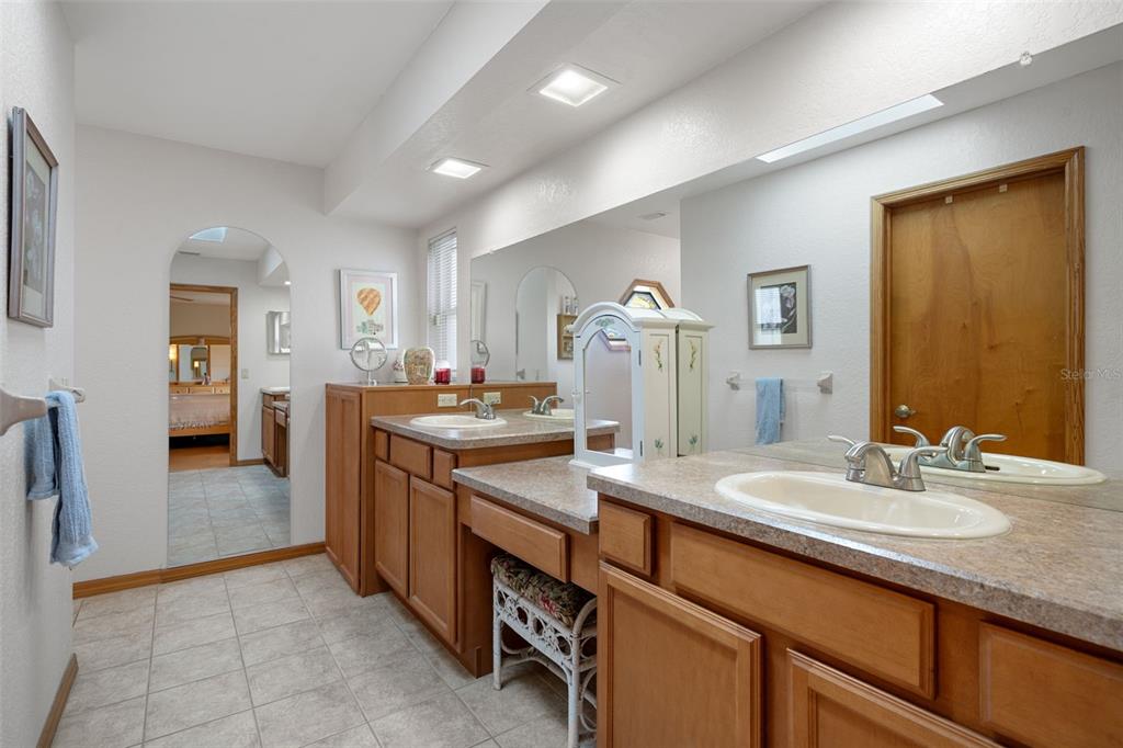 5035 Harbinger Road Spring Hill, FL 34608 - Photo 34 of 47 a bathroom with a granite countertop sink and a mirror