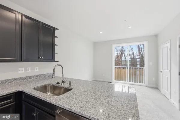 a kitchen with a sink a counter top space and cabinets