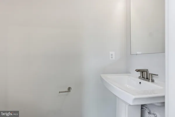 a bathroom with a sink and mirror
