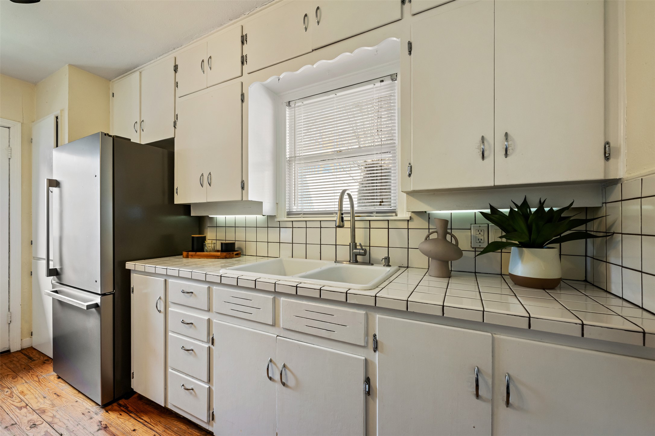 813 East 48th Street Austin, TX 78751 - Photo 15 of 37 a kitchen with stainless steel appliances white cabinets and a refrigerator