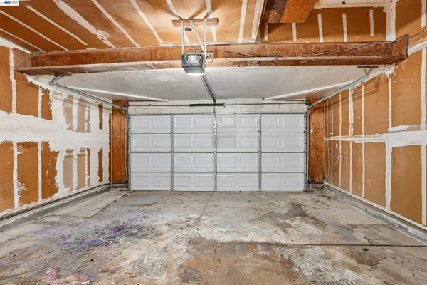 a view of a garage with wooden fence