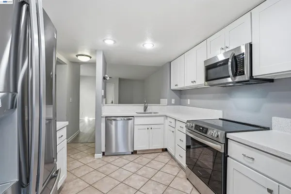 a kitchen with cabinets and stainless steel appliances