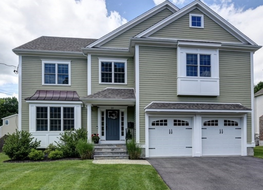 a front view of a house with a yard and porch