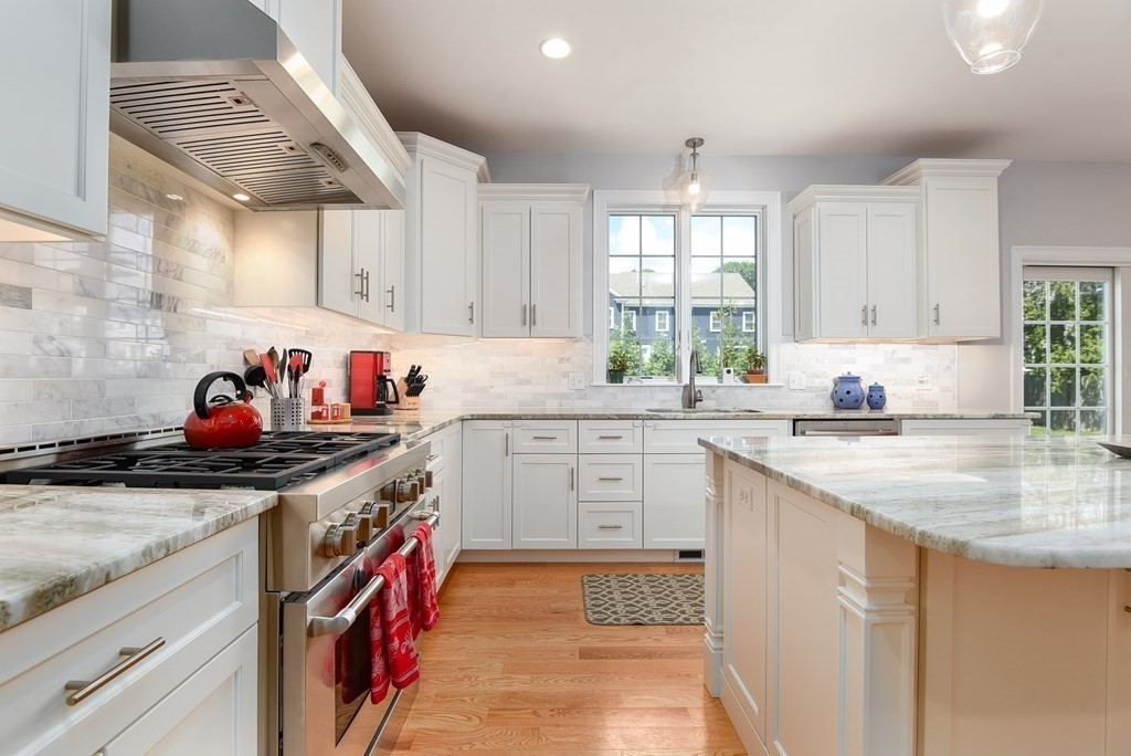 221 Valley Road Needham, MA 02492 - Photo 11 of 42 a kitchen with stainless steel appliances granite countertop a sink stove and cabinets