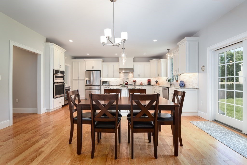 221 Valley Road Needham, MA 02492 - Photo 12 of 42 a view of a dining room and livingroom with furniture wooden floor a chandelier