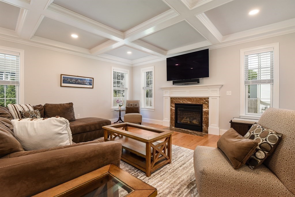 221 Valley Road Needham, MA 02492 - Photo 14 of 42 a living room with furniture a flat screen tv and a fireplace