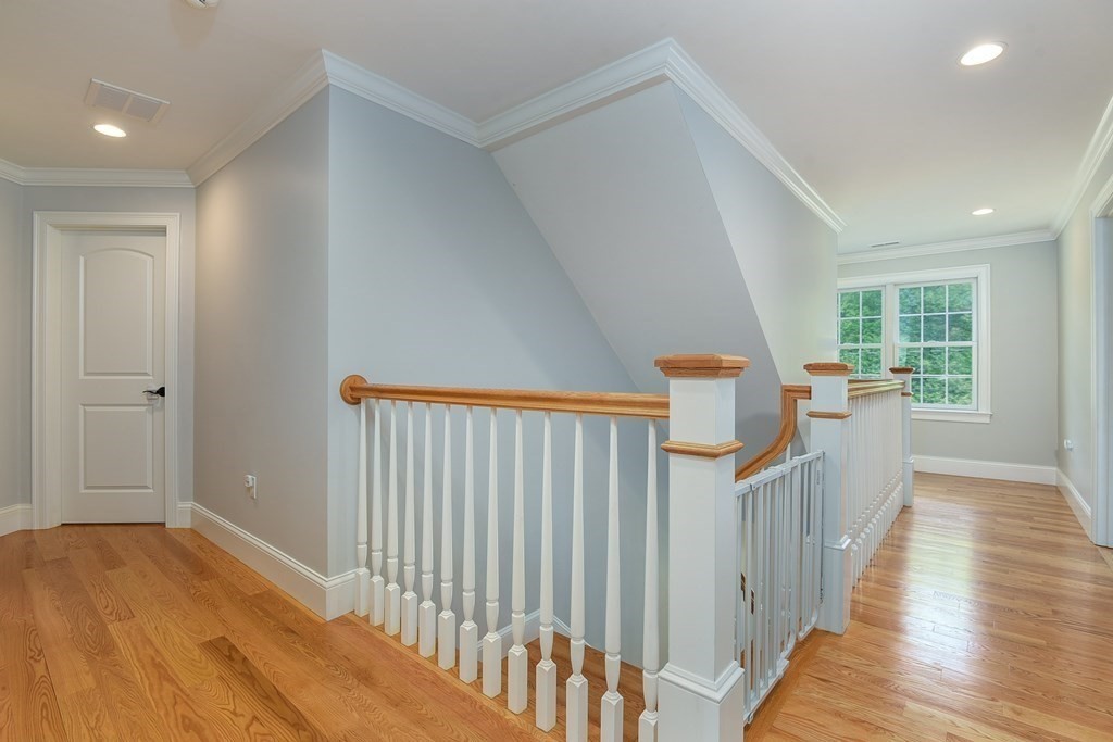 221 Valley Road Needham, MA 02492 - Photo 22 of 42 a view of a hallway with wooden floor and windows