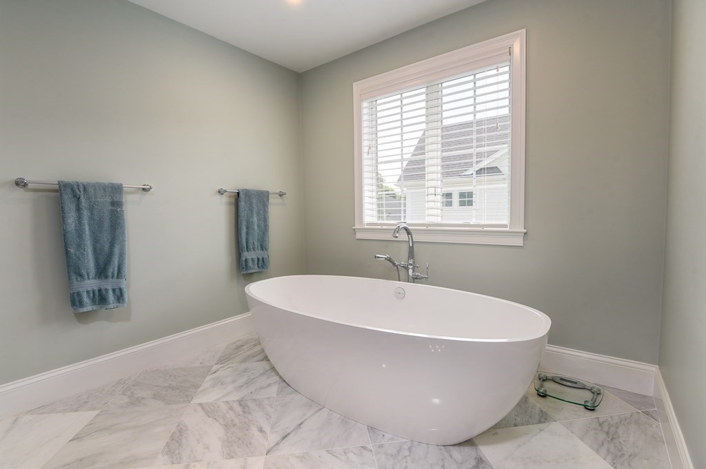 221 Valley Road Needham, MA 02492 - Photo 27 of 42 a white bath tub sitting in a bathroom