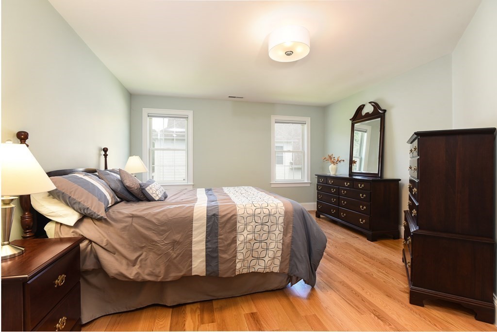221 Valley Road Needham, MA 02492 - Photo 28 of 42 a bedroom with a bed and wooden floor