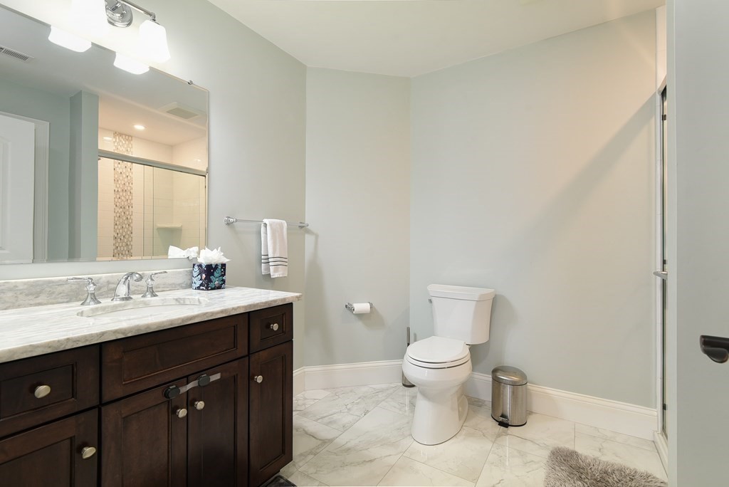 221 Valley Road Needham, MA 02492 - Photo 29 of 42 a bathroom with a toilet sink and mirror
