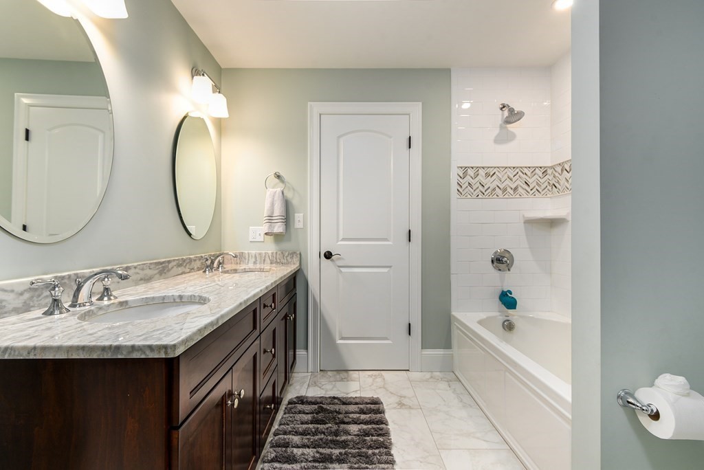 221 Valley Road Needham, MA 02492 - Photo 31 of 42 a bathroom with a granite countertop sink mirror and a bathtub