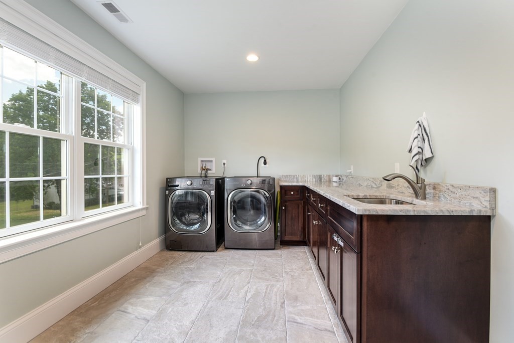 221 Valley Road Needham, MA 02492 - Photo 34 of 42 a utility room with a sink dryer and washer