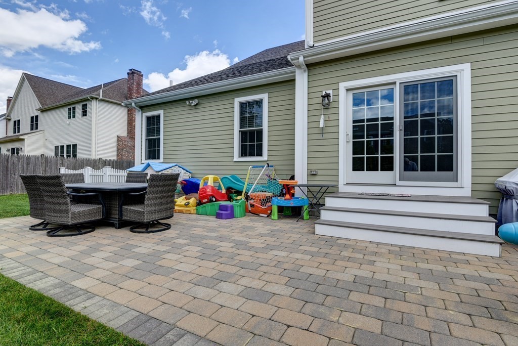 221 Valley Road Needham, MA 02492 - Photo 37 of 42 a view of a house with a patio and a yard