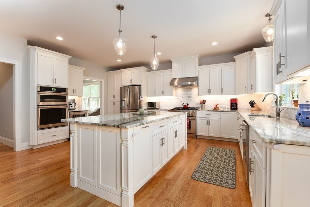 221 Valley Road Needham, MA 02492 - Photo 8 of 42 a kitchen with stainless steel appliances kitchen island granite countertop a sink stove and refrigerator