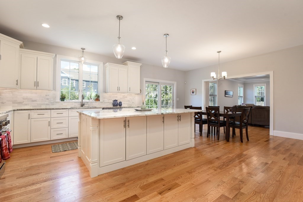 221 Valley Road Needham, MA 02492 - Photo 10 of 42 a large white kitchen with lots of counter space a sink dining table and chairs