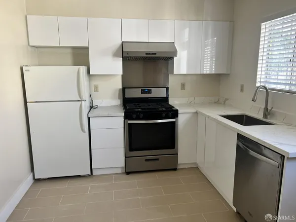 a kitchen with a stove and a refrigerator