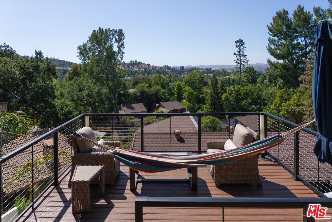 4118 Oak Hollow Road Calabasas, CA 91302 - Photo 25 of 55 a view of a balcony with furniture