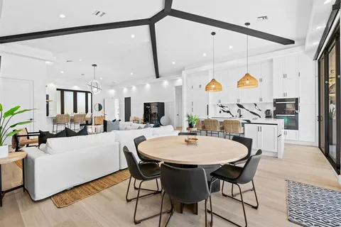 a large kitchen with a table and chairs