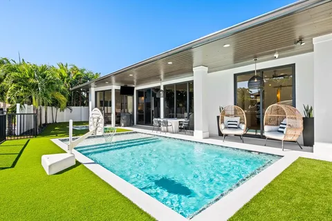 a view of a house with swimming pool and porch with furniture